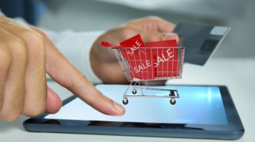 man-playing-tablet-with-shopping-cart (1)